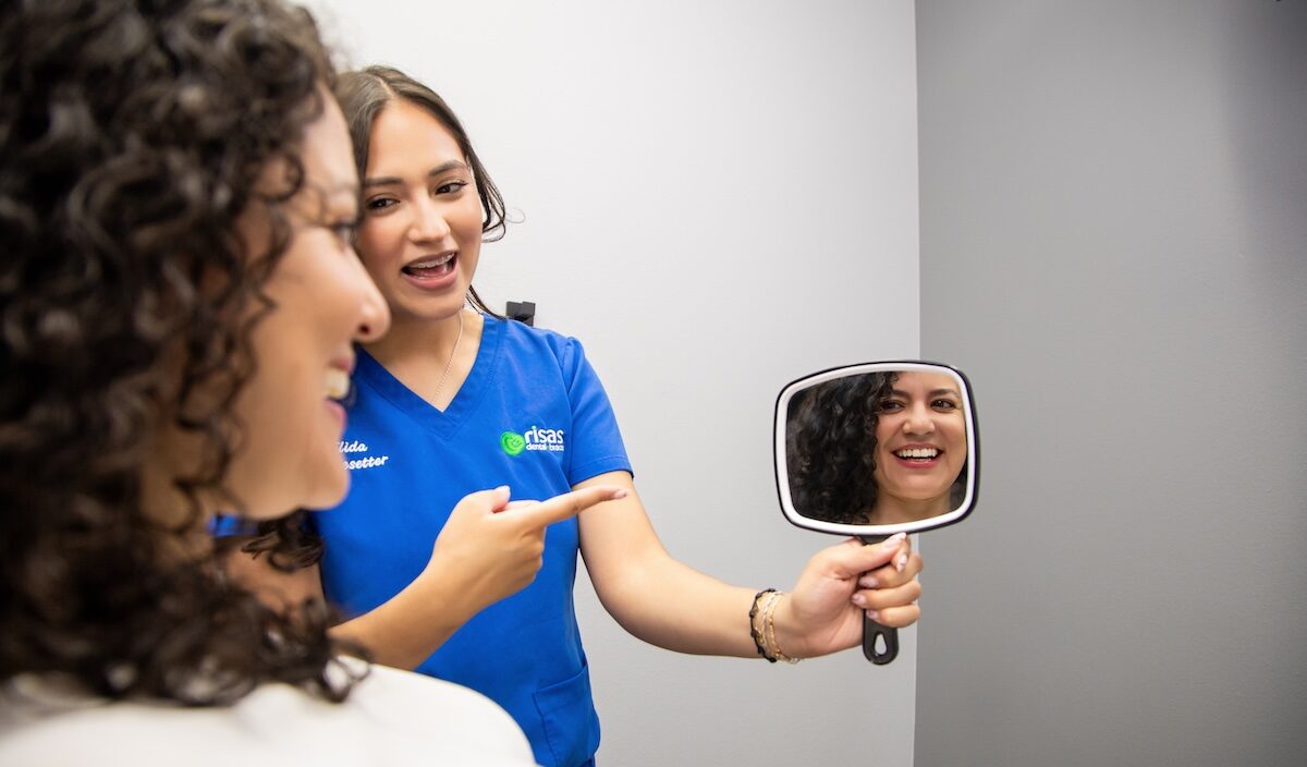 Woman showing her patient steps to take to prepare for braces