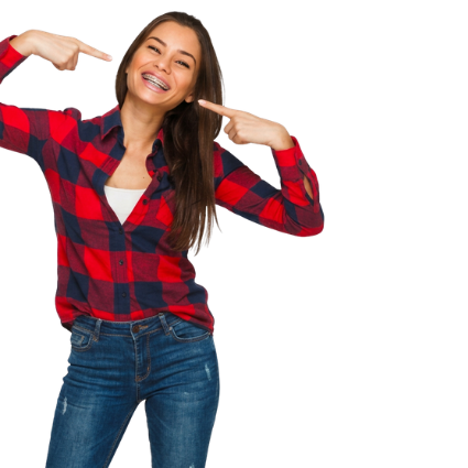 Smiling young woman with braces pointing to her smile